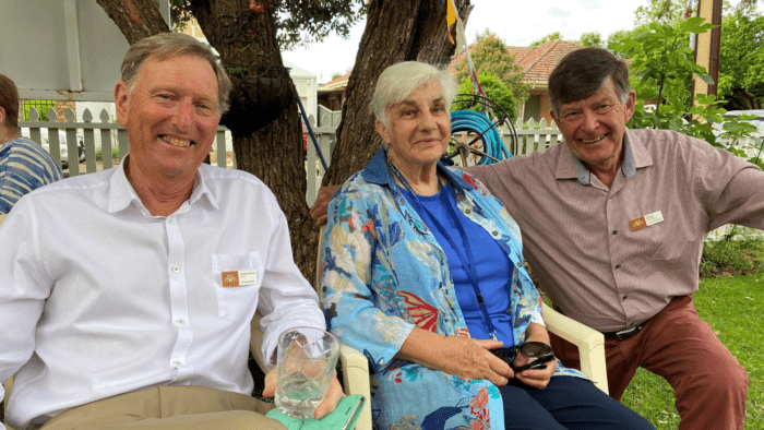 Cottage Homes volunteers sit with resident